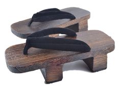 two wooden sandals with black straps on them