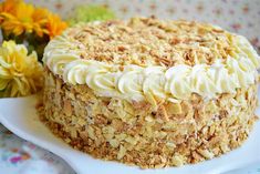 a cake with white frosting and crumbs on it sitting on a plate