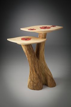 two wooden tables sitting on top of each other in the shape of tree stumps