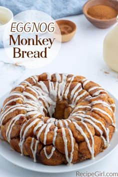 an eggnog monkey bread with icing on a white plate