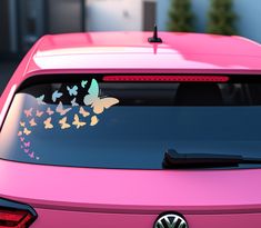 a pink car with butterflies on the windshield