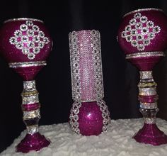 three purple glass vases with diamonds on them