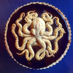 an octopus cake is decorated with chocolate icing