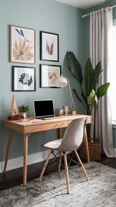 a laptop computer sitting on top of a wooden desk next to a plant in a vase