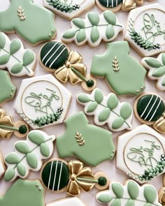 many decorated cookies with green and white decorations