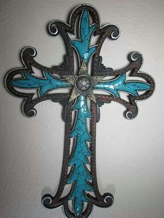 a blue and black cross hanging on the wall