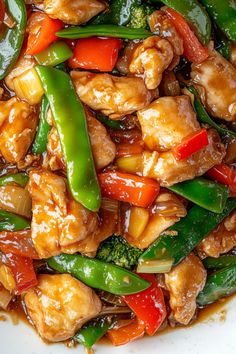 chicken, broccoli, and peppers in a stir fry on a white plate