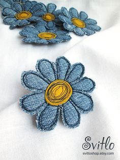 blue and yellow flowers sitting on top of a white cloth