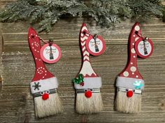 three red and white christmas decorations on wooden boards