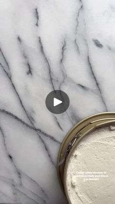 a can of white paint sitting on top of a marble counter