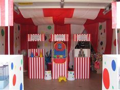 an indoor play area with red and white striped walls