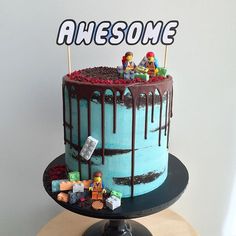 a birthday cake decorated with legos and chocolate drizzled on the top