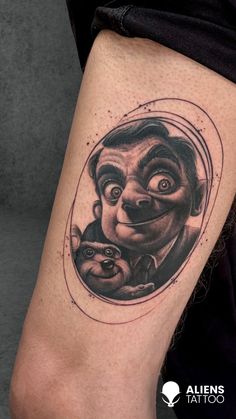 a man's leg with a tattoo on it that has an image of a clown