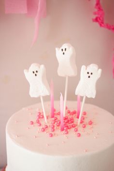 a white cake topped with marshmallows and ghost candies