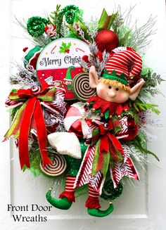 a christmas wreath with an elf and candy canes