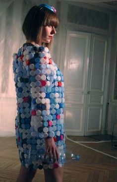 a woman in a dress made out of buttons