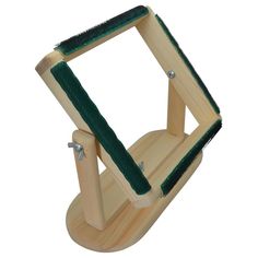 a wooden bird feeder with a green handle