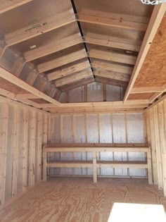 the inside of a storage room with wood walls and ceiling joisting in place