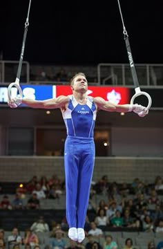 a woman on the rings in front of an audience