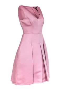 Be the darling dame of your next formal tea in this blush pink dress! This soft and sweet hue of pink adds more of a demure feel to the already ladylike fit and flare silhouette. This would pair gorgeously with a matching slingback heel and shoulder bag! Size 6 100% Polyester Fully lined Fit and flare silhouette Concealed back zipper closure Sleeveless Deep V-neckline Inseam side pockets Bust 32" Waist 28" Shoulder to hem 38" Feminine Pleated Bodice Dress For Prom, Feminine Prom Dress With Pleated Bodice, Feminine Pleated Bodice Cocktail Dress, Dressy Pink Midi Dress For Prom, Feminine Cocktail Dress With Pleated Bodice, Pink Dressy Midi Dress For Prom, Elegant Dress With Sweetheart Neckline And Pleated Back, Pink Sleeveless Midi Dress With Pleated Bodice, Pink A-line Midi Dress For Prom