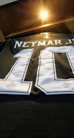 there is a jersey on the bed that says neymar jljg