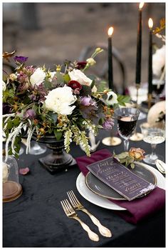 the table is set with flowers and candles