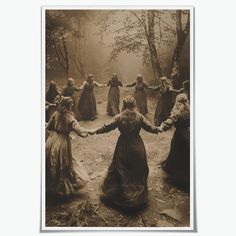 a group of women in long dresses holding hands and walking through the woods on a foggy day