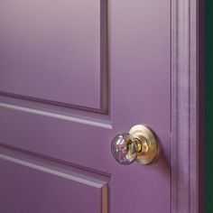 a purple door with a glass knob on it