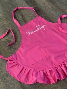 a pink apron with the name bubbly on it