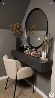 there is a vanity with a mirror on the wall and a chair next to it