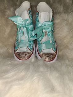 Let Fairy Dust & Glitter add a little fun and magic to your life with these bubble gum inspired bling converse. This is a custom-made high-top white converse with copper and teal pearls accents, embellished with dark gold crystals and highlighted with gold ribbon shoelaces.  The standard design is copper, gold, and teal; however, if you would like different color laces, crystals, or pearls, message us. This design can also be produced in adult sizes.  Please me mindful that all of our products are custom made to order items, therefore, expect variations in color and placement of pearls & crystals. All custom designs take an average of 4-weeks to production to your door Teal Converse, Tiffany Brown, Bling Converse, Gold Crystals, Please Me, Custom Bling, Gold Tie, White Converse, Sneakers Athletic