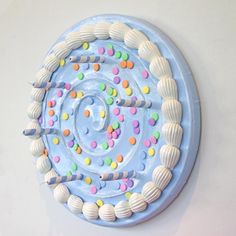 there is a cake decorated with seashells and icing on the top of it