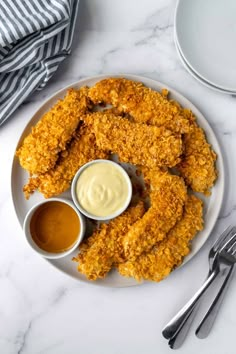 fried chicken on a plate with dipping sauce