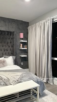 a bedroom with a large bed and gray walls