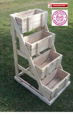 three wooden crates stacked on top of each other in the grass with an award badge above them