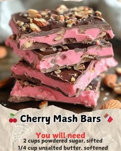 three pieces of cherry mash bars stacked on top of each other with nuts in the background