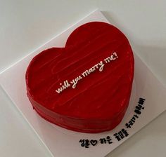 a heart shaped cake with writing on it