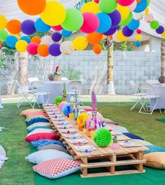 an outdoor party with colorful balloons and decorations