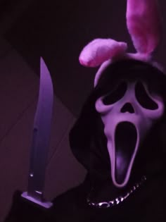 a person wearing a mask and holding a knife