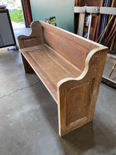 a wooden bench sitting inside of a garage