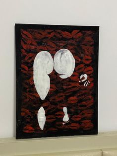 a painting on a white wall with red and black colors