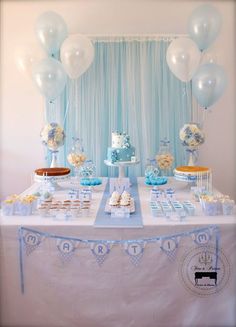 a table topped with lots of cake and balloons