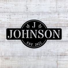 the personalized sign is shown on a wooden wall with white paint and black lettering