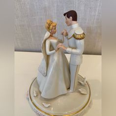 a figurine of a bride and groom holding hands