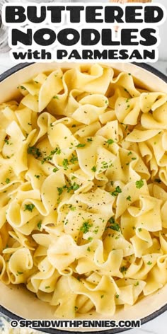 a bowl full of buttered noodles with parmesan cheese and herbs in it