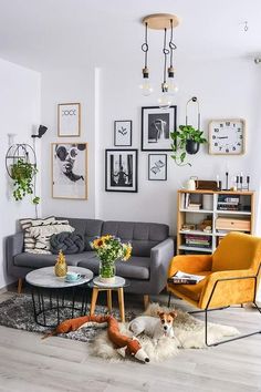 a living room filled with furniture and pictures on the wall