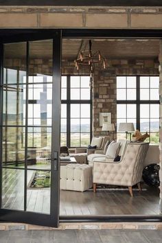 an open living room with glass doors leading to the outside