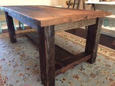 a wooden table sitting on top of a rug