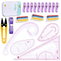 paper crafting supplies including scissors, rulers, and other items on a white background