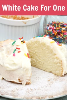 a piece of cake with white frosting and sprinkles on it is sitting on a plate